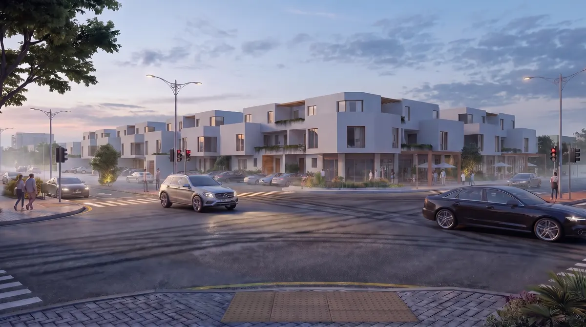 The same street corner in soft morning light with a pale blue sky